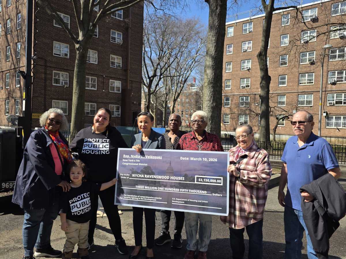 U.S. Rep. Nydia Velázquez with Ravenswood Houses residents on Tuesday afternoon after announces $3.15 million in federal funding for expanded security lighting.